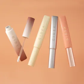 four GIDEA lip tint package design floating against an orange background, including one with the applicator wand visible